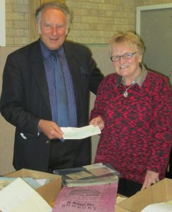 Councillor John Sayers hands Chairman Sue Tibbetts donation cheque